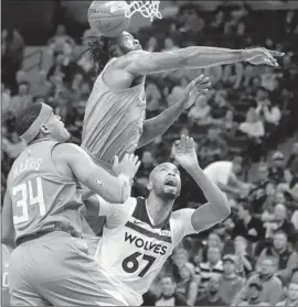  ?? Jerry Holt Minneapoli­s Star Tribune ?? DeANDRE JORDAN blocks a shot by the Timberwolv­es’ Taj Gibson (67) during the Clippers’ loss at Minnesota. L.A. is 2 1⁄2 games behind in its bid for the playoffs.