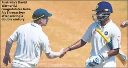  ??  ?? Australia's David Warner (L) congratula­tes India A's Shreyas Iyer after scoring a double century.