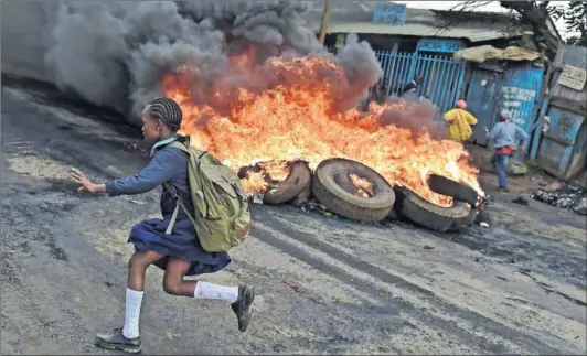  ??  ?? Burning issue: Opposition supporters set up a barricade in Kibera, Nairobi, in May last year, protesting for a change of leadership ahead of this year’s election in August. Photo: Carl de Souza/AFP