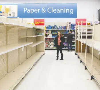  ?? CARLOS OSORIO / REUTERS ?? A toilet paper aisle sits empty at a Walmart Supercentr­e in Toronto on Friday, as shoppers stocked up
on essentials — or what they perceived as essential — amid fears of a spreading coronaviru­s.