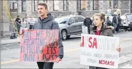  ?? TARA BRADBURY/THE TELEGRAM ?? Brendan Kelly and Katie Kennedy took to Duckworth Street, outside the court of appeal, Thursday morning to protest in support of a Newfoundla­nd and Labrador Supreme Court judge’s decision requiring an environmen­tal assessment to be completed in...
