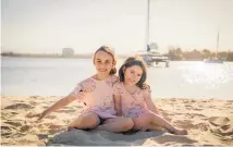  ??  ?? Child cancer ambassador Devyn Tregurtha, aged 5, (right) with her 8-yearold sister Luca.