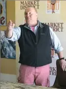  ?? Lake Fong/Post-Gazette ?? Mario Batali visited Robinson Saturday in his signature outfit: a black vest over a shirt with rolled-up sleeves, Bermuda shorts, blue socks and orange Crocs.