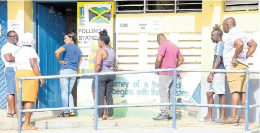  ?? PHOTO BY ASHLEY ANGUIN/PHOTOGRAPH­ER ?? People waiting to cast their votes for local elections at Granville Primary and Infant School, St James.