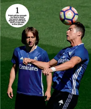  ?? — AFP ?? Real Madrid’s Cristiano Ronaldo (right) heads the ball during a training session.