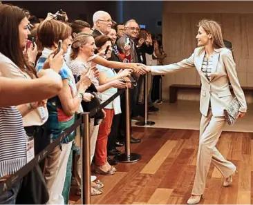  ??  ?? Letizia greeting visitors as she attends the opening of a museum exhibition in Madrid, Spain. She is known to wear Spanish designers for her public appearance­s. – ePa