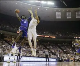  ?? ERIC GAY — THE ASSOCIATED PRESS ?? Kansas guard Josh Jackson (11) shoots over Texas forward Jarrett Allen (31) during the first half of an NCAA college basketball game, Saturday in Austin, Texas.