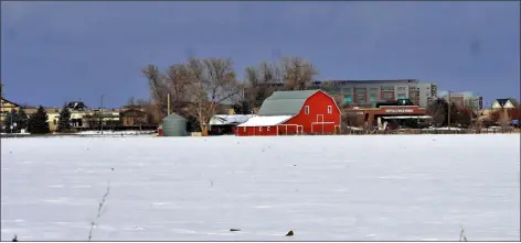  ?? FILE PHOTO ?? A vacant farmhouse and barn currently sit on the otherwise empty property in east Loveland that Mcwhinney Real Estate hopes to turn into the next phase of Centerra. This proposed developmen­t, called Centerra South, would be the first that is part of an urban renewal authority under new state rules.