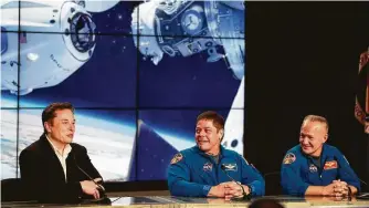  ?? John Raoux / Associated Press ?? SpaceX CEO Elon Musk, left, joins NASA astronauts Bob Behnken, center, and Doug Hurley to discuss the SpaceX launch in Cape Canaveral, Fla., earlier this year.