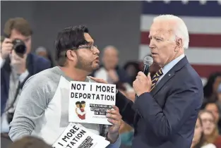  ?? KINNARD/AP FILE
MEG ?? Then-candidate Joe Biden talks with an immigratio­n advocate during a town hall at Lander University in Greenwood, S.C., in November 2019.