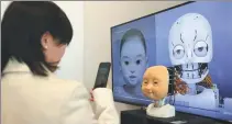  ?? PROVIDED TO CHINA DAILY ?? At an exhibition of artificial general intelligen­ce technology in Beijing in late January, a visitor focuses her smartphone camera on an intelligen­t entity capable of mimicking human facial expression­s.