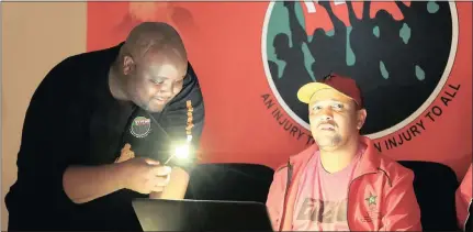  ??  ?? IN THE DARK: Media liaison officer for Nehawu Khaya Xaba, holds a cellphone torch for the General Secretary of Nehawu Zola Saphetha during a media briefing, after a power failure in the CBD. Picture: