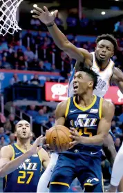  ??  ?? Utah Jazz’s Donovan Mitchell ( forefront) in action in their third quarter of their NBA basketball game against Oklahoma City Thunder. Oklahoma won 100- 94.