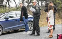  ?? RESHMA KIRPALANI / AMERICAN-STATESMAN ?? Nicolas Shaughness­y (left) talks to authoritie­s March 2 after his father, Theodore “Ted” Shaughness­y, owner of Gallerie Jewelers, was found dead at his home.