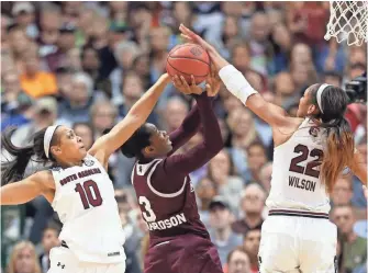  ?? MATTHEW EMMONS, USA TODAY SPORTS ?? South Carolina’s Allisha Gray, left, and A’ja Wilson block a shot by Breanna Richardson.