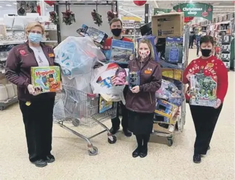  ??  ?? Staff at Sainsbury’s in Silksworth – from left, Julie Newrick Rob Fraser Dawn Hutchinson and Brenda Eltringham – with some of the presents.