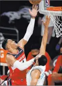  ?? Mark J. Terrill The Associated Press ?? Washington’s Russell Westbrook soars for a basket as Los Angeles’ Talen Horton-tucker defends in the first half.