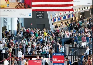  ?? AP file photo ?? Passengers wait to pass through security earlier this year at Logan Internatio­nal Airport in Boston. Consumer advocates see good and bad things in two bills being considered by Congress that will affect travelers.