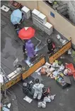  ?? HECTOR RETAMAL/AFP VIA GETTY IMAGES ?? People linger near a checkpoint on a street during a COVID-19 lockdown in the Jing’an district in Shanghai last week.