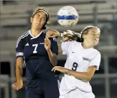  ??  ?? Freeport's Kimmy Mixon goes for a header against Burrell's Megan Malits. Freeport won, 2-0.