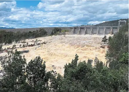  ?? — AFP ?? Deep trouble: Floodwater­s overflowin­g from Wyangala dam’s spillways near the town of Cowra.