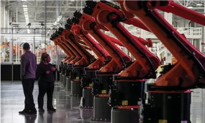  ?? Photograph: Elijah Nouvelage/Reuters ?? Robotic arms for an assembly line at a Mercedes-Benz electric vehicle battery factory near Vance, Alabama, in 2022.