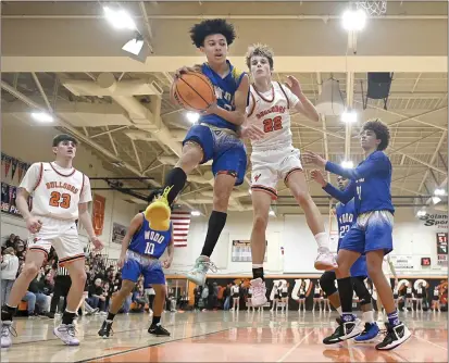  ?? JOEL ROSENBAUM — THE REPORTER ?? Will C. Wood's Cory Edwards (3) secures the ball as he fights for control of a rebound with Vacaville High's Jake Knight (22) during the third quarter of the Bulldogs' 65-57victory over the Wildcats Thursday at Harold Youngblood Gymnasium. With the win, the `Dogs secured a tie for the Monticello Empire League title with Vanden High, and wait for its seeding in the Sac-Joaquin Section Playoffs that will be released this afternoon.