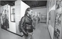  ?? [TOM DODGE/DISPATCH PHOTOS] ?? Columbus State Community College student Taryn Toone studies the “Poindexter Village: A Portrait in Stories” exhibit at the Ohio History Connection. The exhibit opened on Saturday.