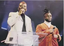  ??  ?? Alloysious Massaquoi, left, and Kayus Bankole collect the 2018 SAY Award during Thursday’s ceremony at Paisley Town Hall