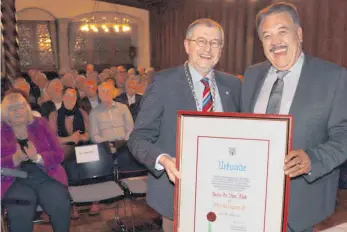  ?? FOTO: DIK ?? Uwe Birk (rechts) strahlt, als OB Gerhard Ecker ihm beim Festakt vor etwa 90 Gästen die Urkunde überreicht, die ihn zu Lindaus Ehrenbürge­r macht.