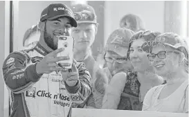  ?? Phelan M. Ebenhack / Houston Chronicle ?? Darrell Wallace Jr., the first black driver to start the Daytona 500 since 1969, draws a crowd as he mingles with fans during Saturday’s Daytona 500 practice.