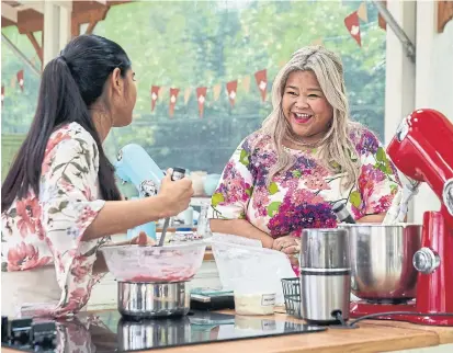  ?? CBC ?? Host Ann Pornel, right, checks in with a contestant on “The Great Canadian Baking Show,” a series defined by its uplifting spirit.