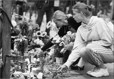  ??  ?? People lay flowers at the site of a car accident in Berlin, Germany. (Photo: The Guardian)