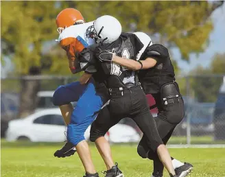  ??  ?? TAKING A BIG HIT: BU neurology professor Robert Stern, top, says a new study he co-authored shows children 12 and under take great risks playing tackle football.