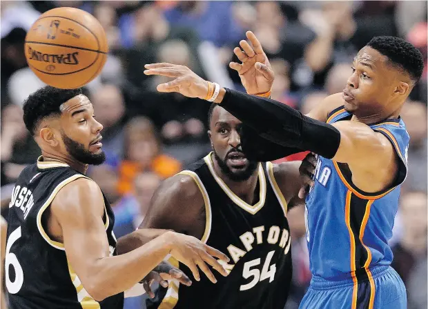  ?? NATHAN DENETTE / THE CANADIAN PRESS ?? Oklahoma City Thunder guard Russell Westbrook moves the ball past Toronto Raptors guard Cory Joseph and Patrick Patterson during NBA action Thursday. Westbrook was a one-man wrecking crew with 24 points in a 123-102 Thunder win.