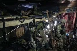  ?? EVGENIY MALOLETKA — THE ASSOCIATED PRESS ?? Ukrainian paratroope­rs of 80Air Assault brigade rest inside a dugout at the frontline near Bakhmut, Ukraine, on Friday.