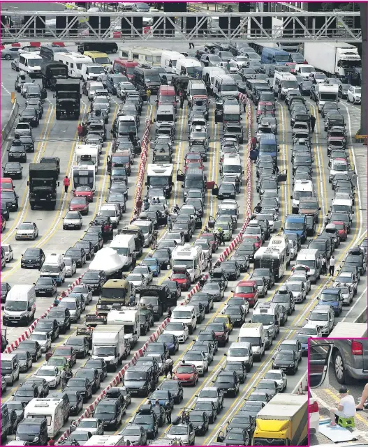  ?? Pictures: IAN FORSYTH / GETTY ?? Summer brake... huge queues at Dover yesterday while, right, sunbathing was all one frustrated motorist could do