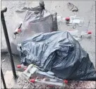  ?? (Photo: John O’Connell) ?? Two large bin bags full of glass bottles that were dumped on the Cork Road in Fermoy.