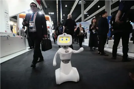  ?? SIMON DAWSON/BLOOMBERG PHOTO ?? Robelf, a multi-camera home security robot, waves at the Mobile World Congress in Barcelona, Spain, on Feb. 26.