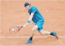  ??  ?? Canada’s Denis Shapovalov returns a shot to John Millman of Australia during their first-round match in Paris.