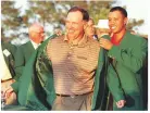  ??  ?? He received his Green Jacket from 1997 champion Tiger Woods