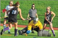  ?? BARRY TAGLIEBER - FOR DFM ?? Phoenixvil­le’s Katie Baker and Lucy O’Donnell close in on West Chester Rustin’s Megan Hadfield tries to clear the ball during their District 1-2A playoff game Wednesday.