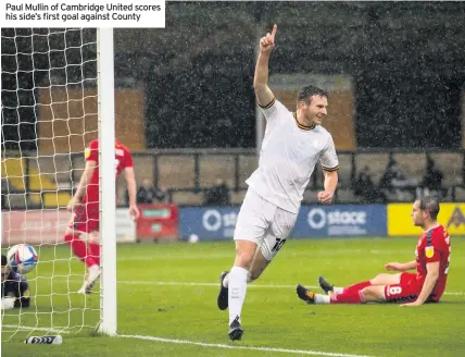  ??  ?? Paul Mullin of Cambridge United scores his side’s first goal against County