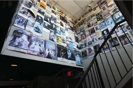  ?? RICHARD LAUTENS PHOTOS/TORONTO STAR ?? Posters of acts gone by adorn the walls of the stairwell.