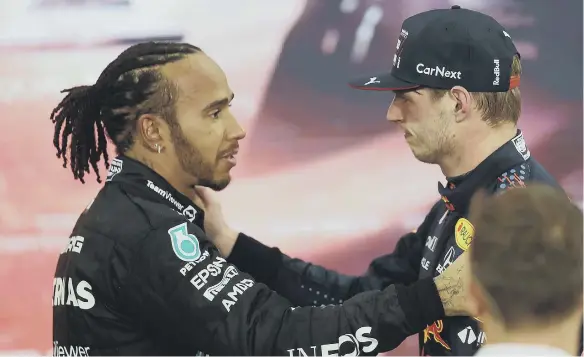 ?? ?? Race winner and 2021 F1 World Drivers Champion Max Verstappen, of Red Bull Racing, is congratula­ted by runner up in the race and championsh­ip Lewis Hamilton, of Mercedes GP.