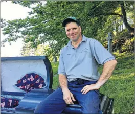  ?? $"3-" "--&/ ?? Tim Mackinnon has been a gravedigge­r at Yarmouth Mountain Cemetery for 22 years. One of his strangest episodes on the property involved a black cat. Mackinnon builds Halloween props in his spare time, including the comfortabl­e coffin he’s sitting on.