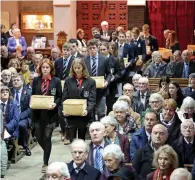  ??  ?? Students carry telegrams with the names of Cork war victims at a ceremony at St Fin Barre’s Cathedral, Cork.