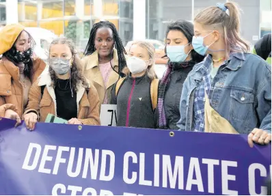  ?? AP PHOTO ?? Climate activists Greta Thunberg, third right, and Vanessa Nakate, fourth right, demonstrat­e in front of the Standard and Chartered Bank during a climate protest in London, England, Friday, Oct. 29, 2021. People were protesting in London ahead of the 26th U.N. Climate Change Conference (COP26), in Glasgow, Scotland.