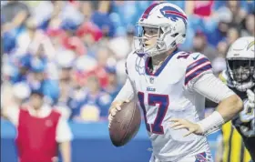  ?? Brett Carlsen / Getty Images ?? Josh Allen of the Bills runs with the ball against the Los Angeles Chargers. Los Angeles defeated Buffalo 31-20 in the Week 2 matchup.