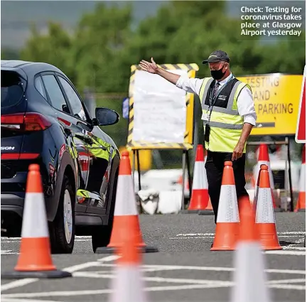  ??  ?? Check: Testing for coronaviru­s takes place at Glasgow Airport yesterday